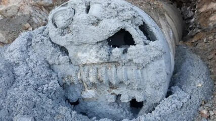 Close-up view of small tunnel boring machine on construction site. 