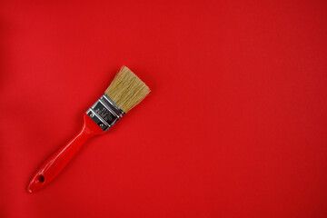 Red construction brush on red background