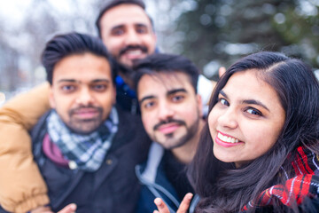arabic guys having great time on Christmas holidays taking selfie photo on phone