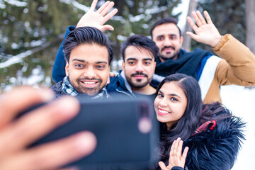 arabic guys having great time on Christmas holidays taking selfie photo on phone