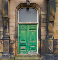 Old green double door in wooden frame