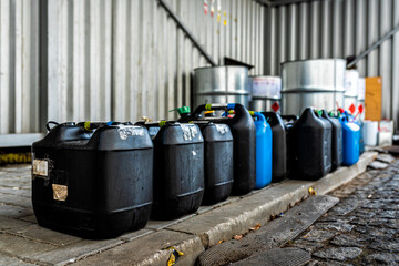 Plastic containers containing chemical waste from laboratories, business and industry background,...