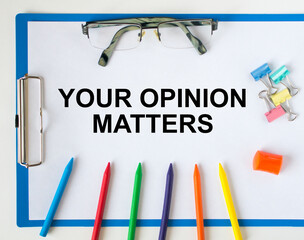 A clipboard with text Your Opinion Matters eyeglasses paper clips