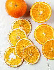 dried and fresh orange on white background
