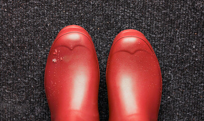 Gummistiefel rot auf Fu&szlig;matte