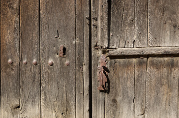 antique brown wooden door with an handle and a lock
