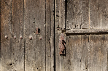 antique brown wooden door with an handle and a lock