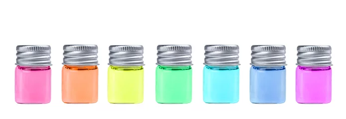 Foto op Canvas Glazen flessen met kleurrijke vloeistof geïsoleerd op een witte achtergrond. © Albert Ziganshin