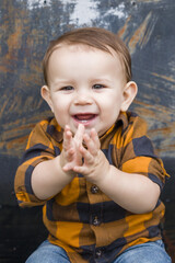 A baby boy eleven months old outdoors in the winter in a downtown setting.