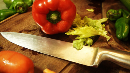 fresh vegetables in the kitchen ready to cut, carrots, peppers, lemons, tomatoes, cucumbers and other vegetables on a cutting board