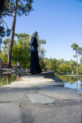 Muslim tourist girl standing and looking to the water