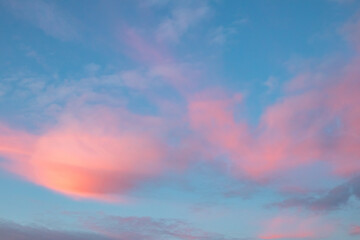 Clouds illuminated by purple sunset, in a blue sky, Sesimbra.
