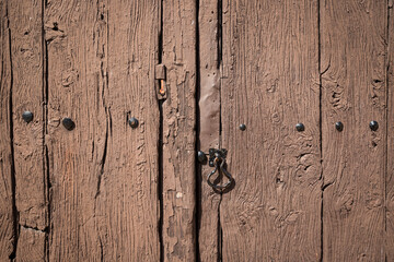 antique brown wooden door with an old door knocker