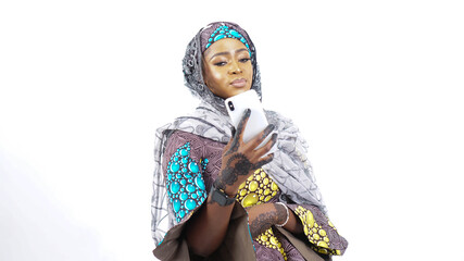 Fototapeta premium Portrait of pretty African Fulani woman using a mobile phone 