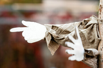 signs of pointers in different directions against a blurred city bsckground