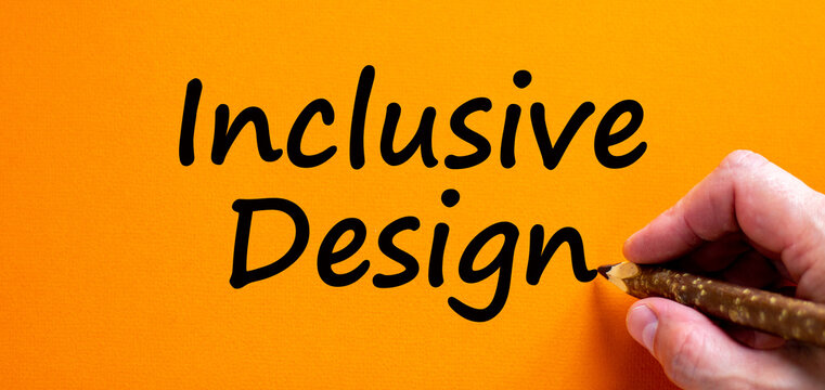 Inclusive design symbol. Hand writing 'inclusive design', isolated on orange background. Business, inclusion and inclusive design concept. Copy space.