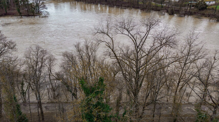 Aerial view from of Aare river with high level water because of melting brown snow water in winter time.