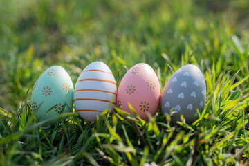 decoor painted easter eggs in the grass in nature for the Easter holiday in spring