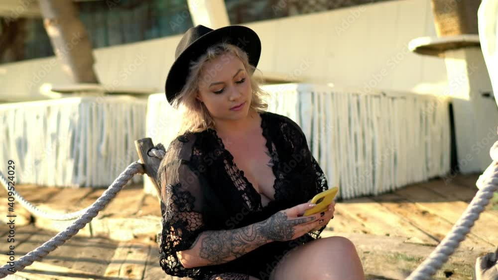 Poster caucasian female blogger enjoying smartphone browsing via cellphone application, millennial woman in
