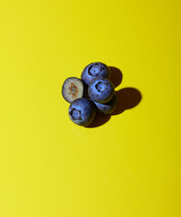 Blueberries on yellow background