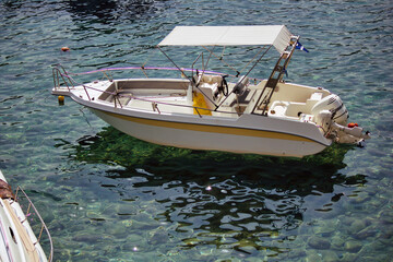 Fototapeta premium Kreta or Crete, Greece - September 10, 2017: A motor boat floating on a clean water on a mediterranean sea
