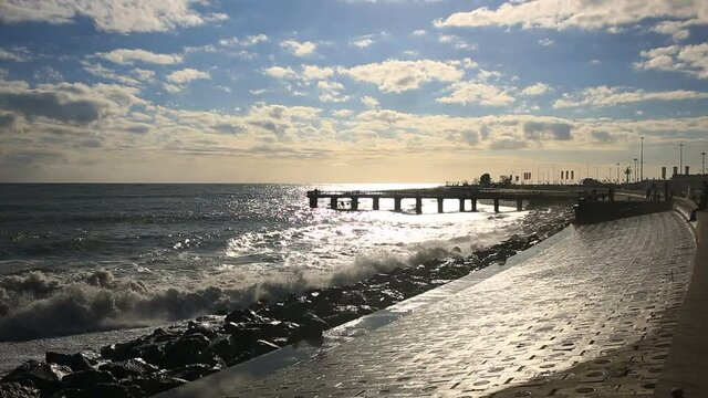 Sea storm, huge waves of foaming are broken against stones.