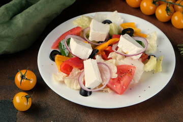 Greek salad on a dark wooden background