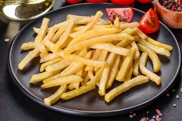 Fresh hot french fries with salt vegetables and spices