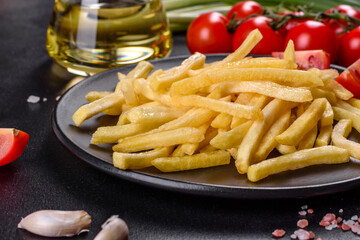 Fresh hot french fries with salt vegetables and spices