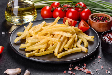 Fresh hot french fries with salt vegetables and spices