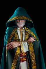 The wise old wizard wearing a hooded cloak.