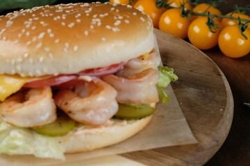 Burger with curves on a wooden background