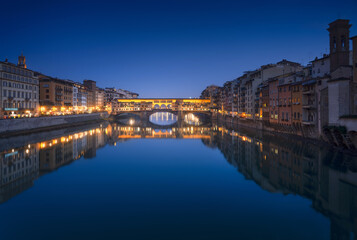 Ponte Vecchio bridge and Arno river in Florence at sunset. Tuscany, Italy.