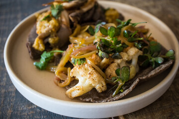 Vegan Mexican Food - featuring a cauliflower taco and a bean empanada topped with mushrooms