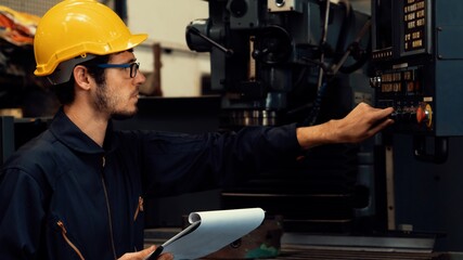 Skillful factory worker working with clipboard to do job procedure checklist . Factory production...