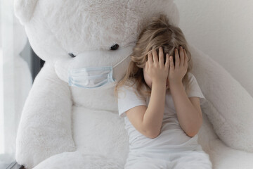 Girl of 5 years is hiding her face from someone