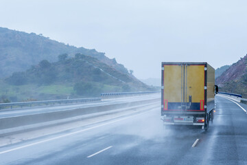 Refrigerated truck driving on the highway on a day complicated by the rain.