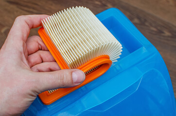 Manual replacement of the air filter in a modern washing vacuum cleaner. The master removes the...