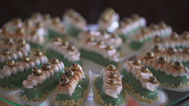Candy bar at a celebration in a restaurant. Sweets are well laid out on the table.