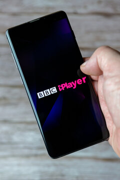 01-30-2021 Portsmouth, Hampshire, UK A hand holding a mobile phone or cell phone with the BBC Iplayer app open on screen