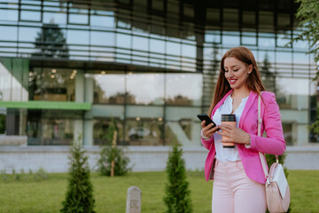 Beautiful woman using mobile phone on the street