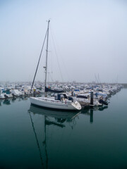 Fototapeta premium Boats in the fog in the bay of Cadiz capital, Andalusia. Spain. Europe. 
