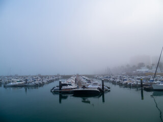 Fototapeta na wymiar Boats in the fog in the bay of Cadiz capital, Andalusia. Spain. Europe. 