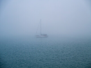 Boat in the fog in the bay of Cadiz capital, Andalusia. Spain. Europe.
