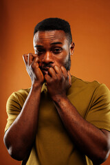 young pretty african american man posing cheerful on brown background, lifestyle people concept