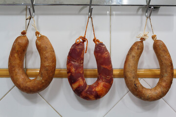 Portuguese smoked sausages, alheira and chorizo hanging for dry