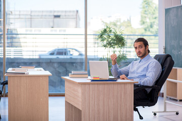 Young male teacher in the classroom