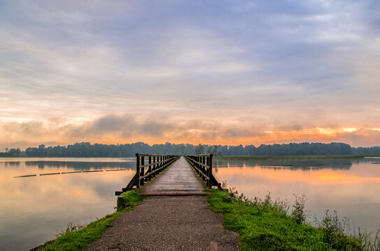 Early morning at sunrise by the lake Sirvena in Birzai - the longest wooden bridge in Lithuania