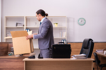 Young male employee being dismissed from his work