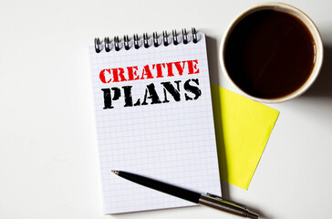 action plan text on notebook with calculator on wooden desk.